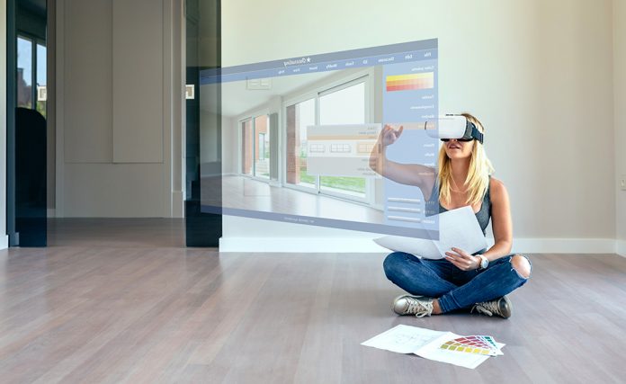 woman-decorating-with-virtual-reality-glasses-WLLQDNB-696x42